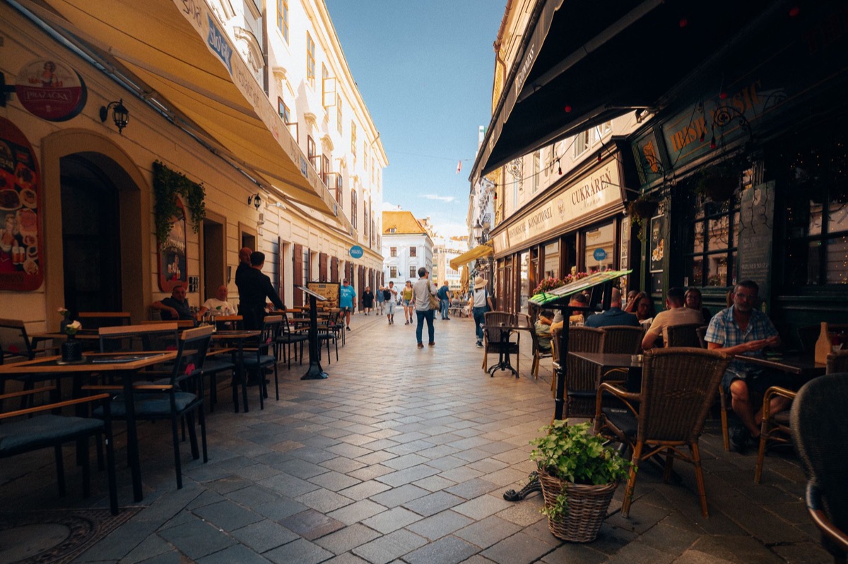 A bustling urban cafe environment with people and ambient movement